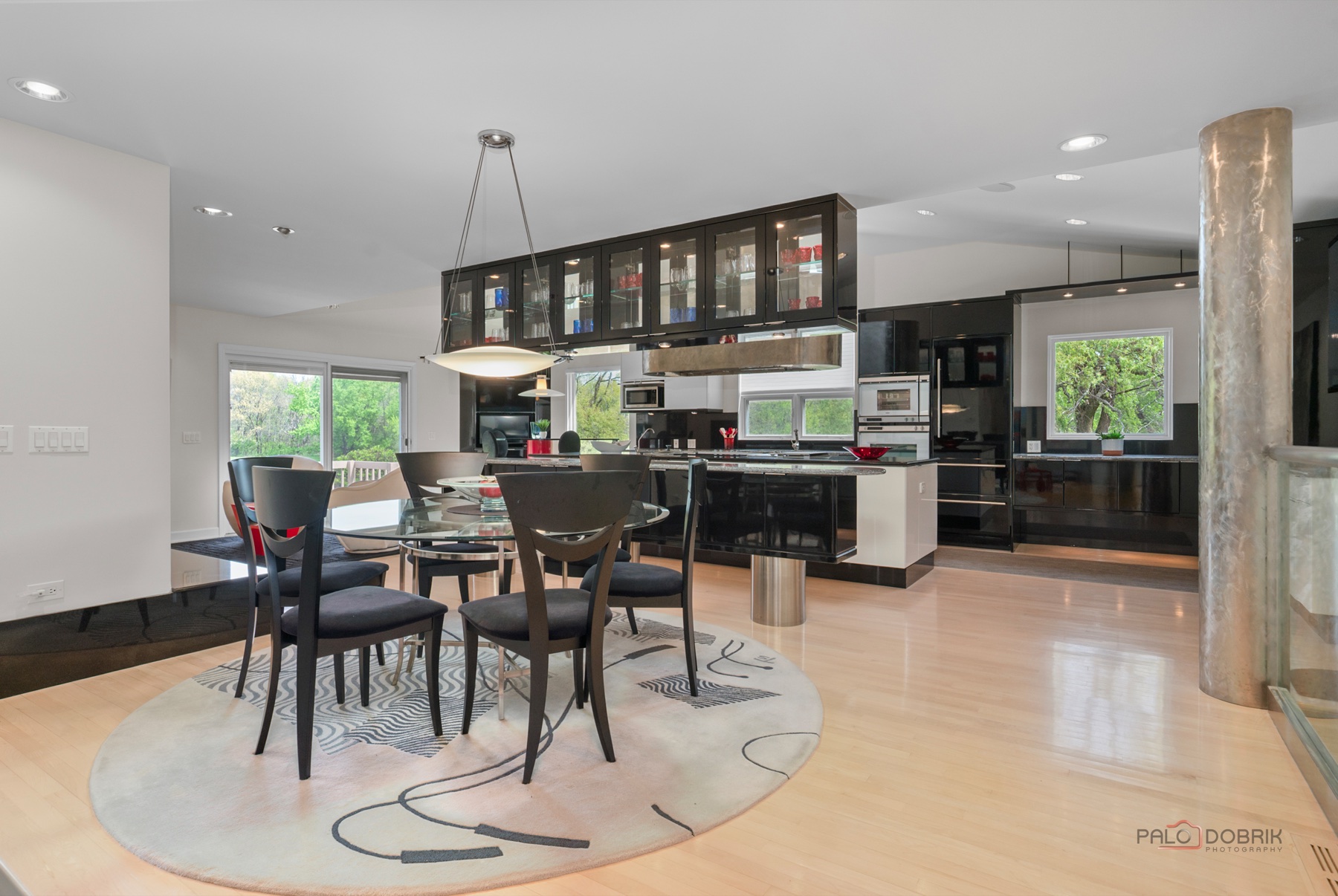 Open kitchen and dining area remodeled with black and white cabinetry