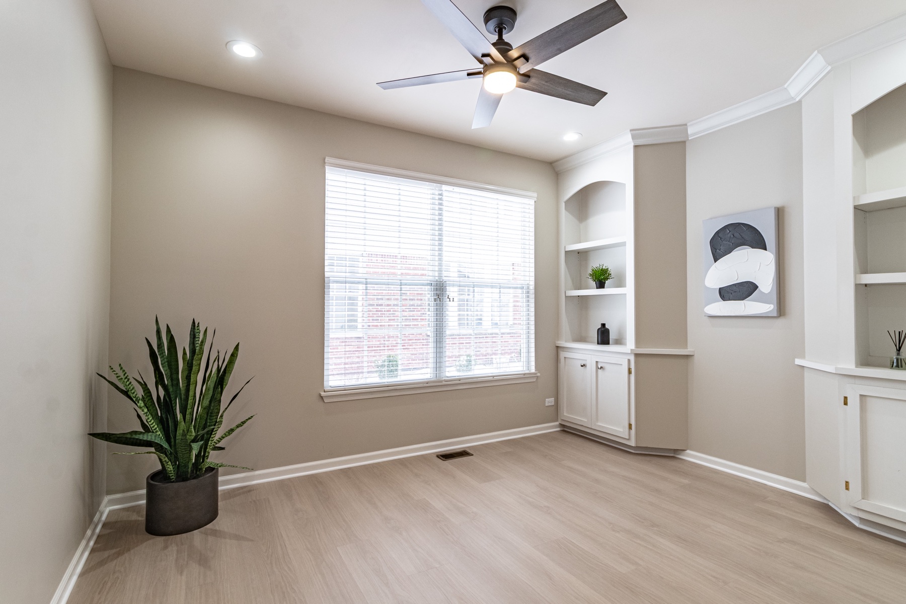 Fresh flooring and built-in shelving in a finished room