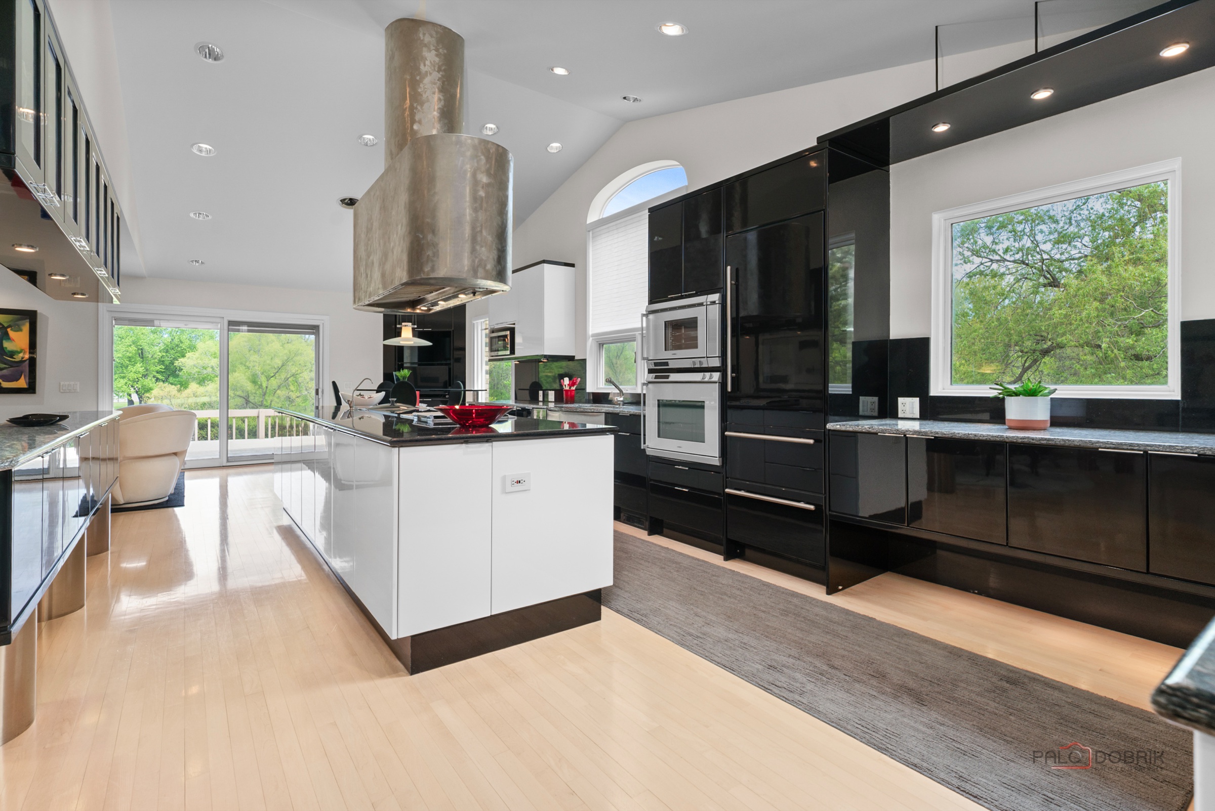 Finished kitchen remodel with black cabinetry and white island